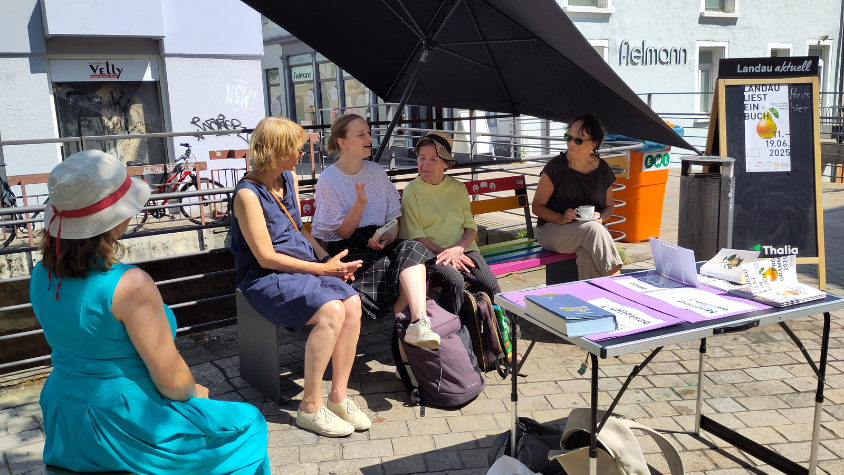 People sitting down on a bench in Landau