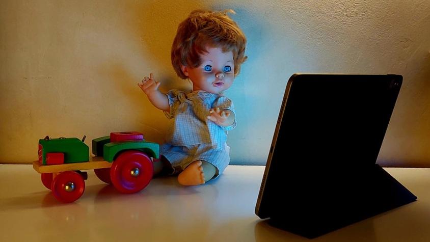 Eine Puppe sitzt vor einem Ipad