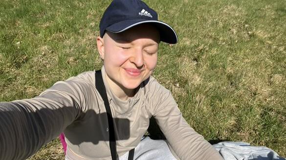 A girl sitting on the ground.